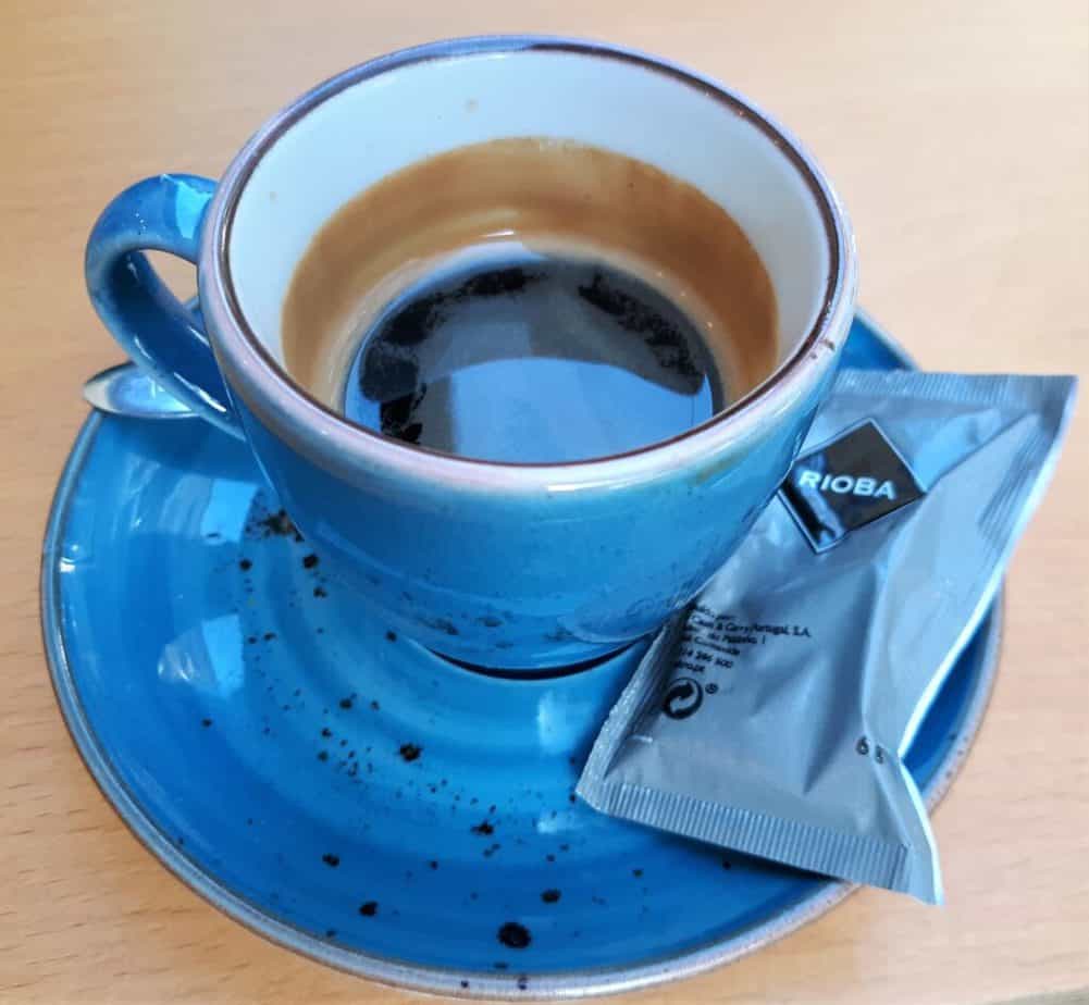 Espresso in a blue cup and saucer.