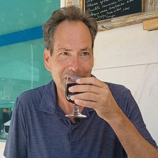 Man enjoying a glass of red wine.