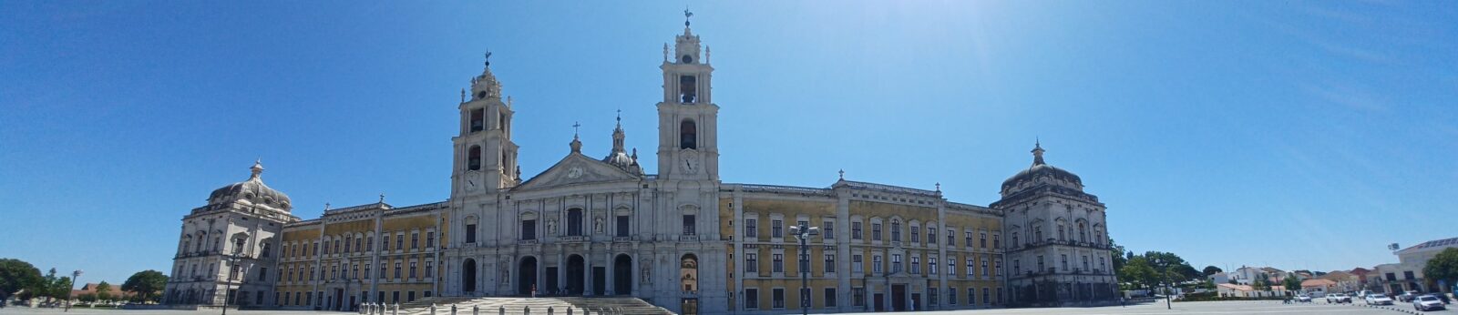 A large building with a clock tower in the middle of it.