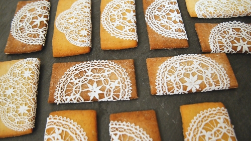 A close up of some cookies with lace on them