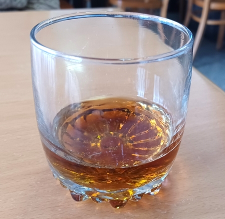 A glass of whiskey on the table