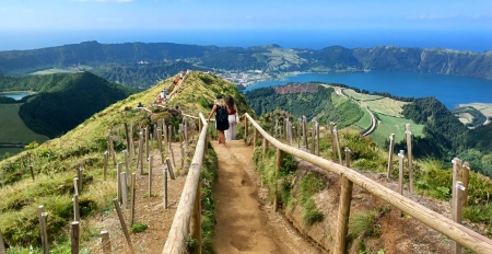 A couple of people are walking up the hill