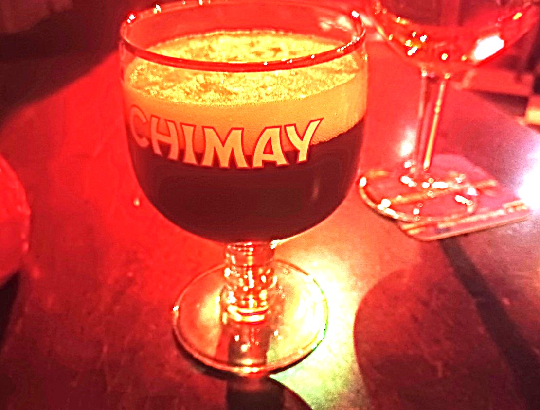 A glass of chimay is on the table.